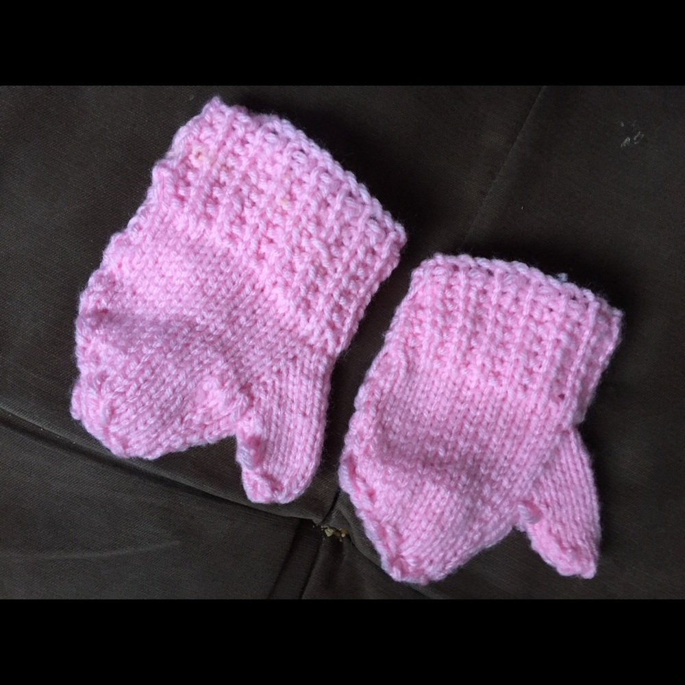 Baby hand knitted mittens with thumb